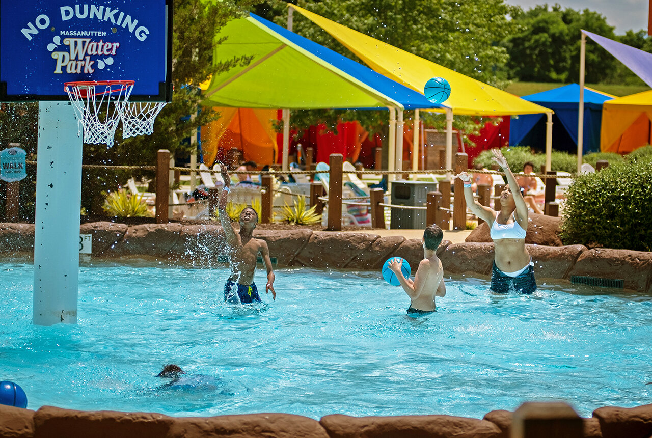 Guests playing basketball in the pool at the Outdoor WaterPark