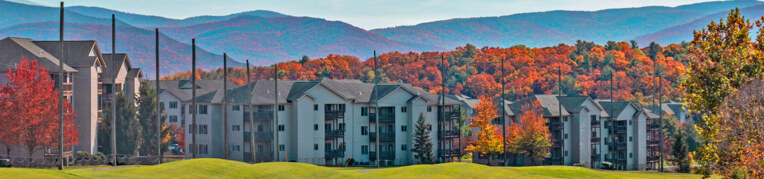 A view of the Woodstone Meadows condos with the mountains in the backgound at Massanutten Resort