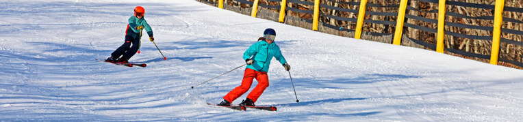 Two guests skiing at Massanutten Resort