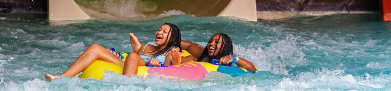 Two guests on a tube slide at the Massanutten Indoor WaterPark