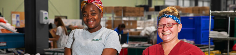 Two employees working at the laundry facilities at Massanutten