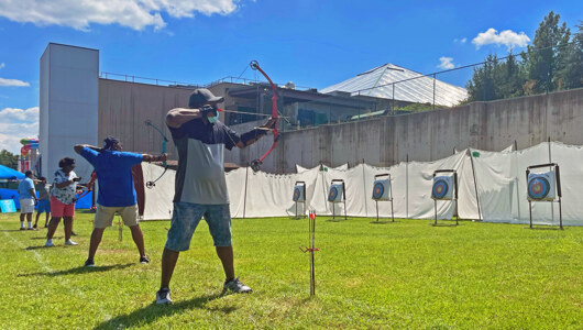 Guests taking an archery class at Massanutten Resort