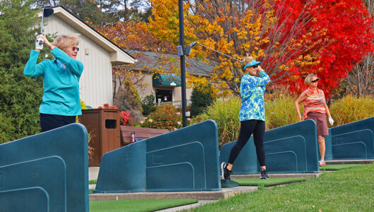 Guests at the driving range at Massanutten Resort