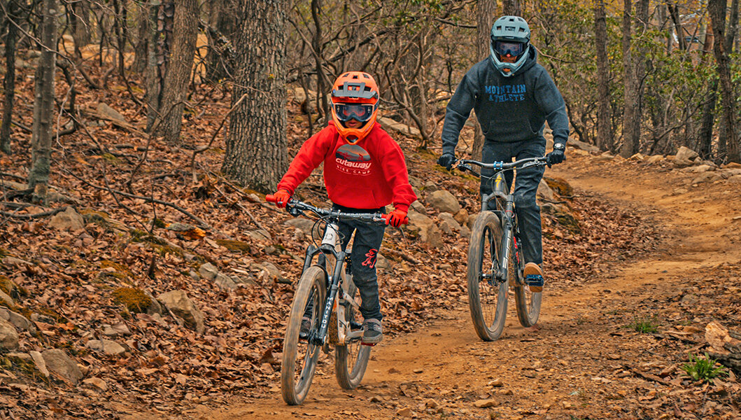 A boy and a dad mountain biking at Massanutten's Bike Park