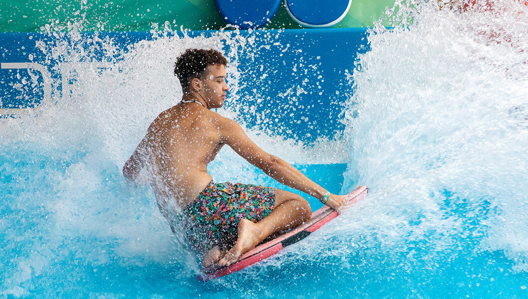 A guest on the flowrider at the Indoor WaterPark