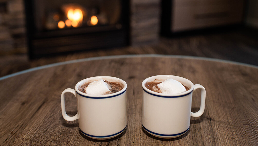 Two mugs of hot chocolate in a condo at Massanutten Resort